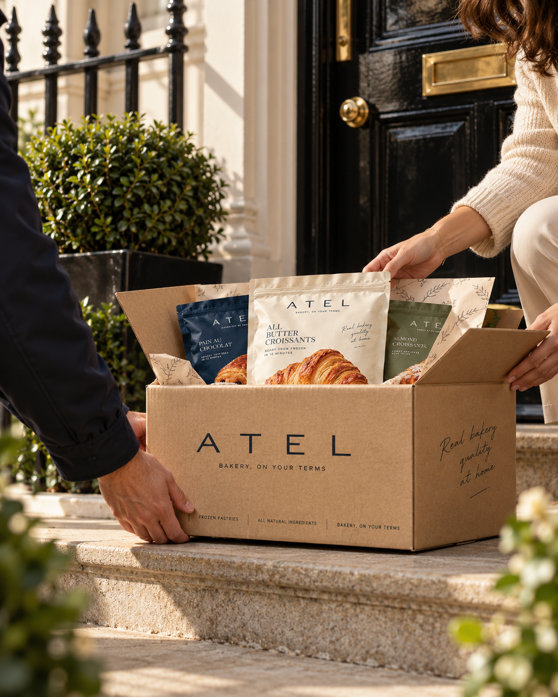An ATEL delivery box of frozen pastries being handed over at the front door